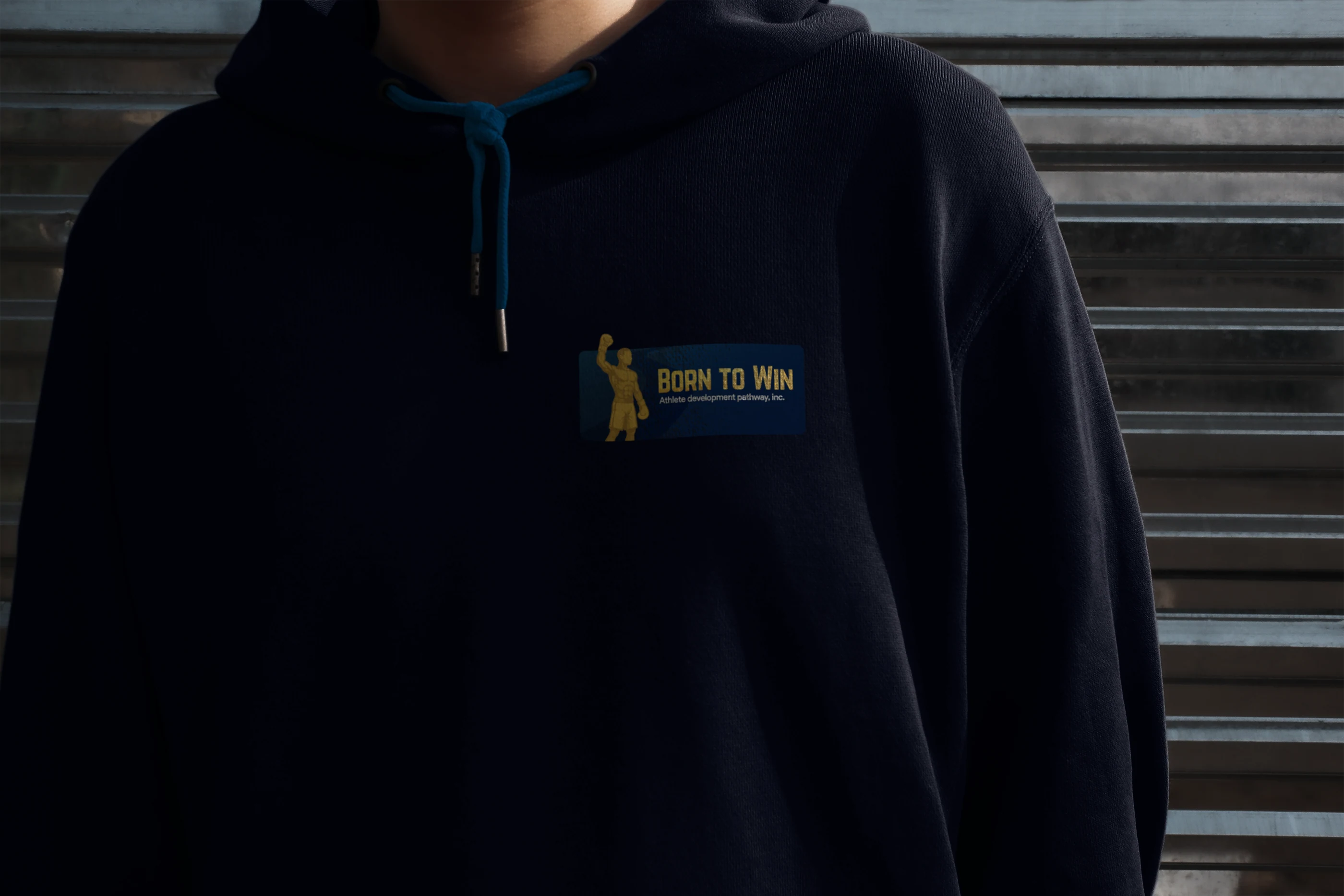 Born to Win plaque printed on the chest of a navy hoodie