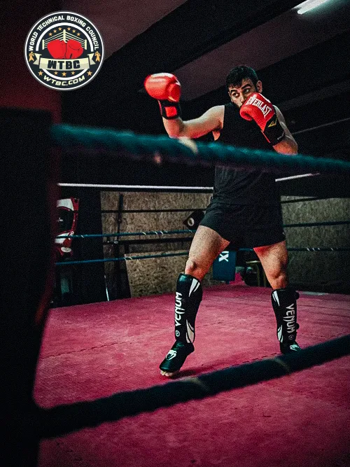 Fighter shadow boxing in an empty ring